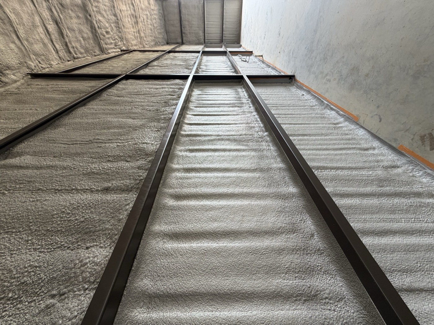 Long metal agricultural building sealed with spray foam