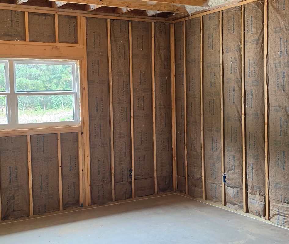 Fiberglass batts installed between framed walls
