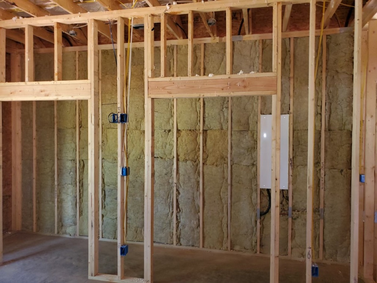 Batt insulation fitted between framed walls in an East Texas home