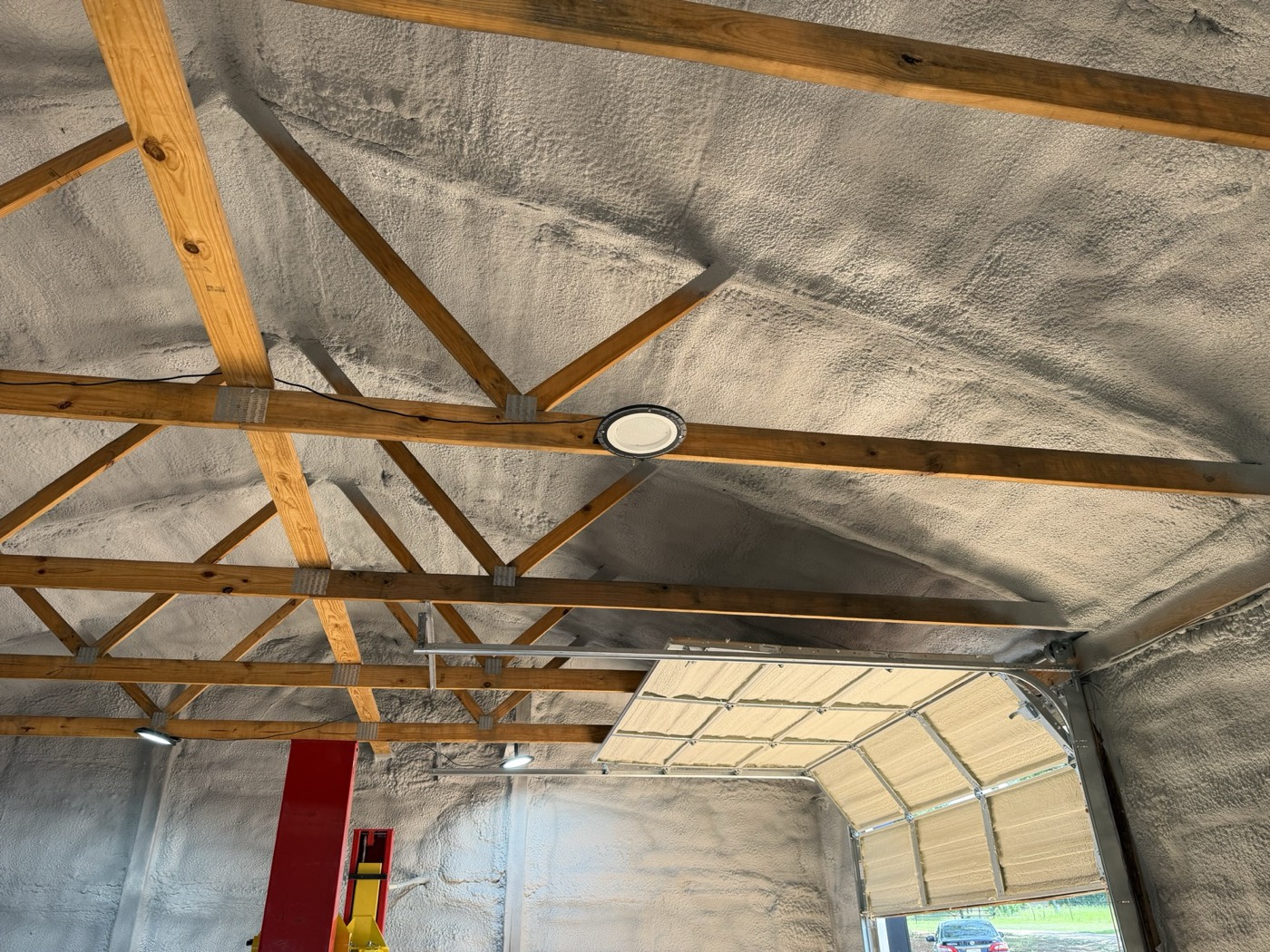Roof deck and trusses insulated with spray foam