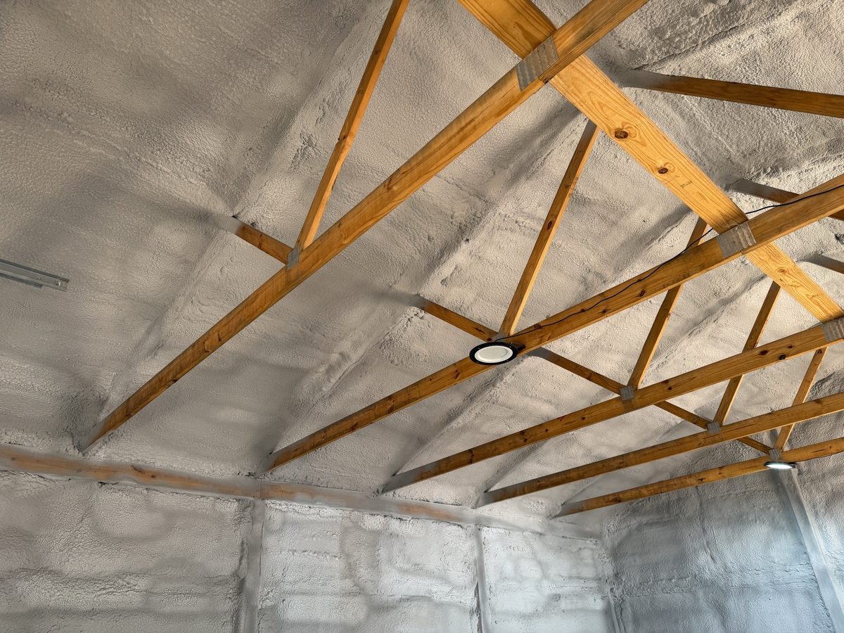 Dyed open-cell spray foam under wood roof trusses