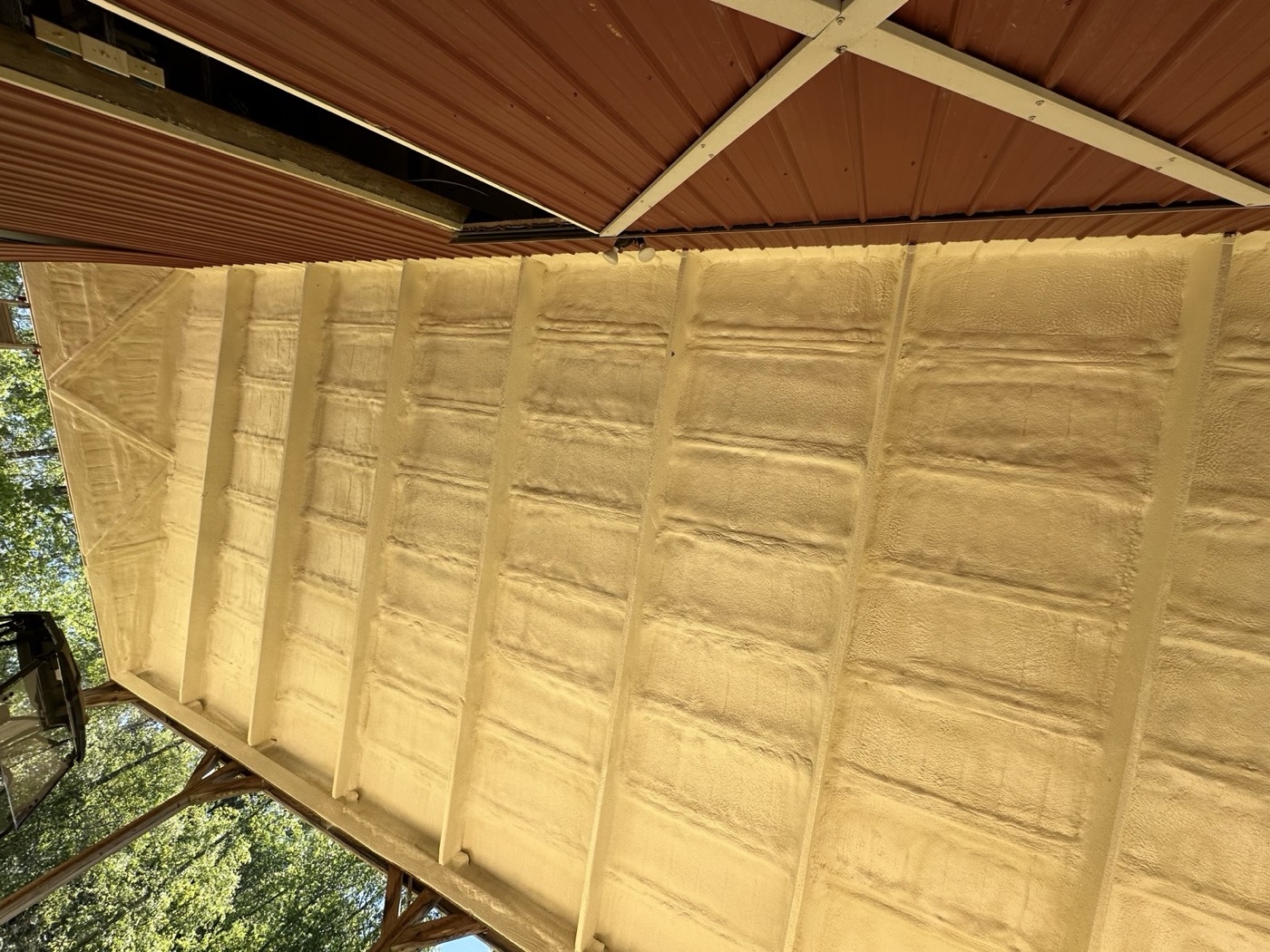 Open-cell spray foam applied to a roof deck