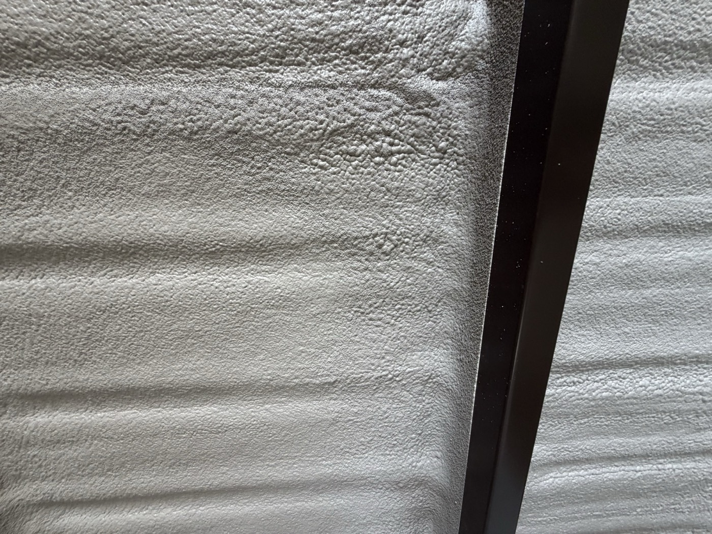 Exposed spray foam before a fire-protective coating