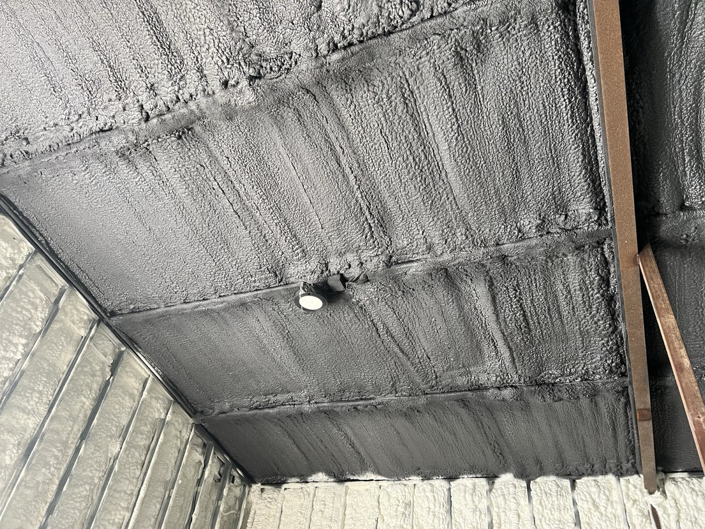 Spray foam applied to a ceiling deck